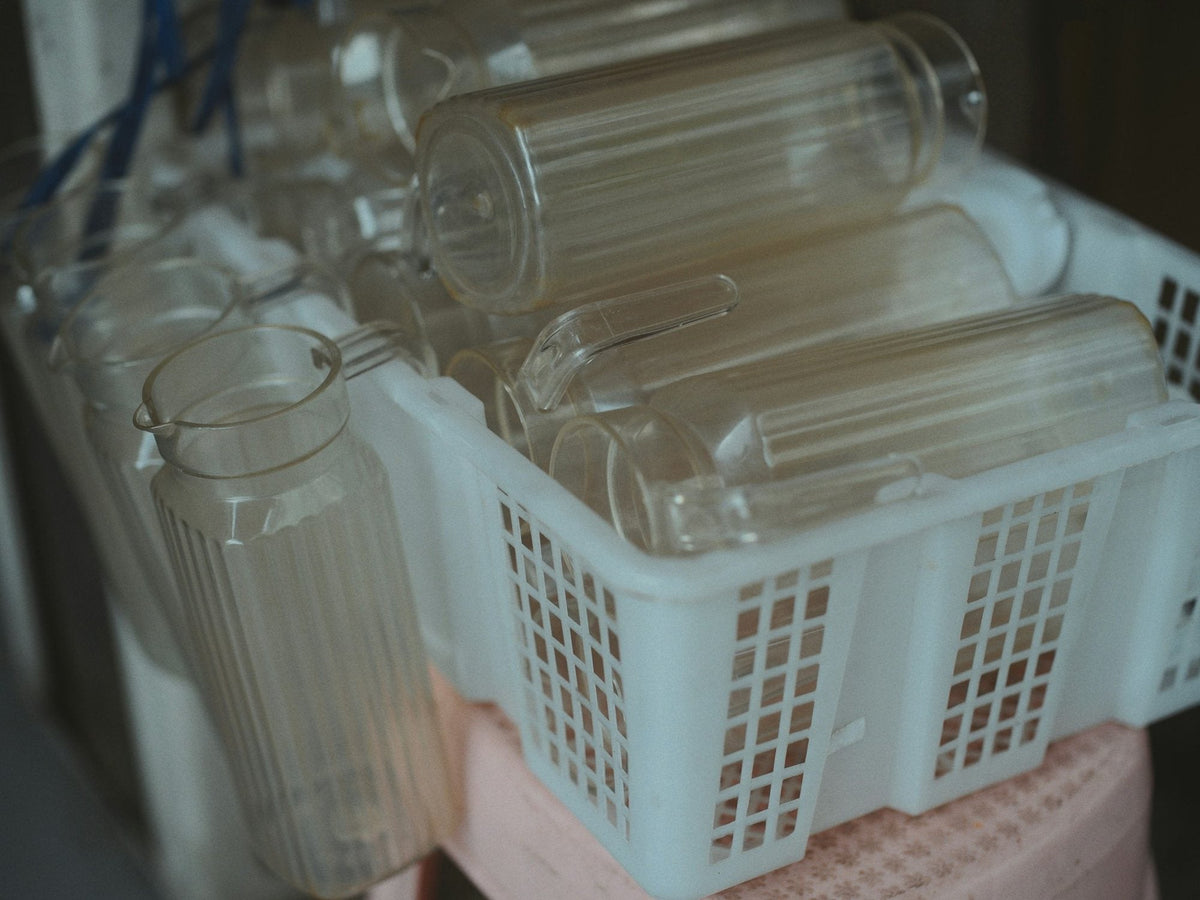 Clear bottles drying in a basket