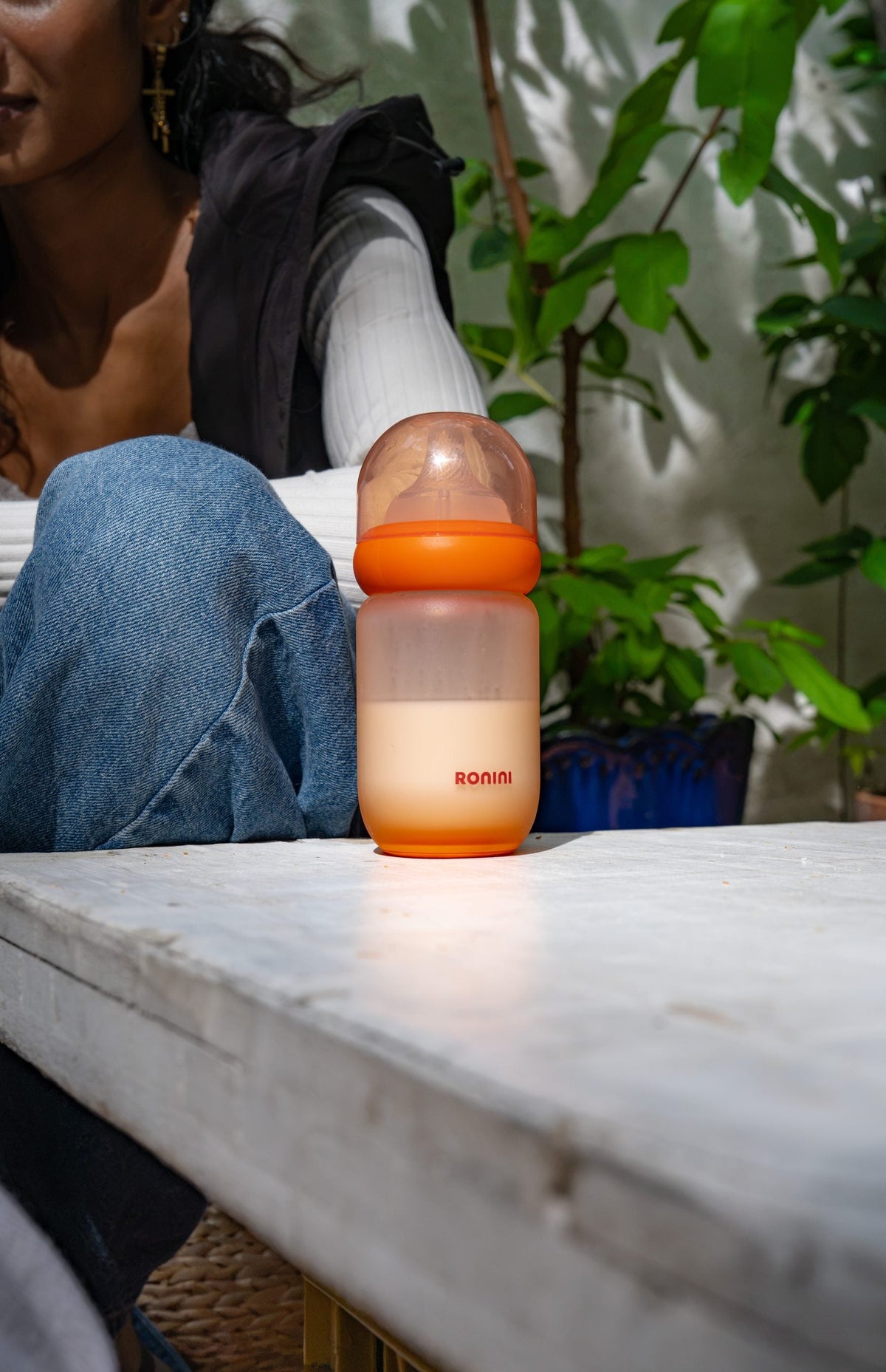 The Wrapped Glass Bottle standing on a white table