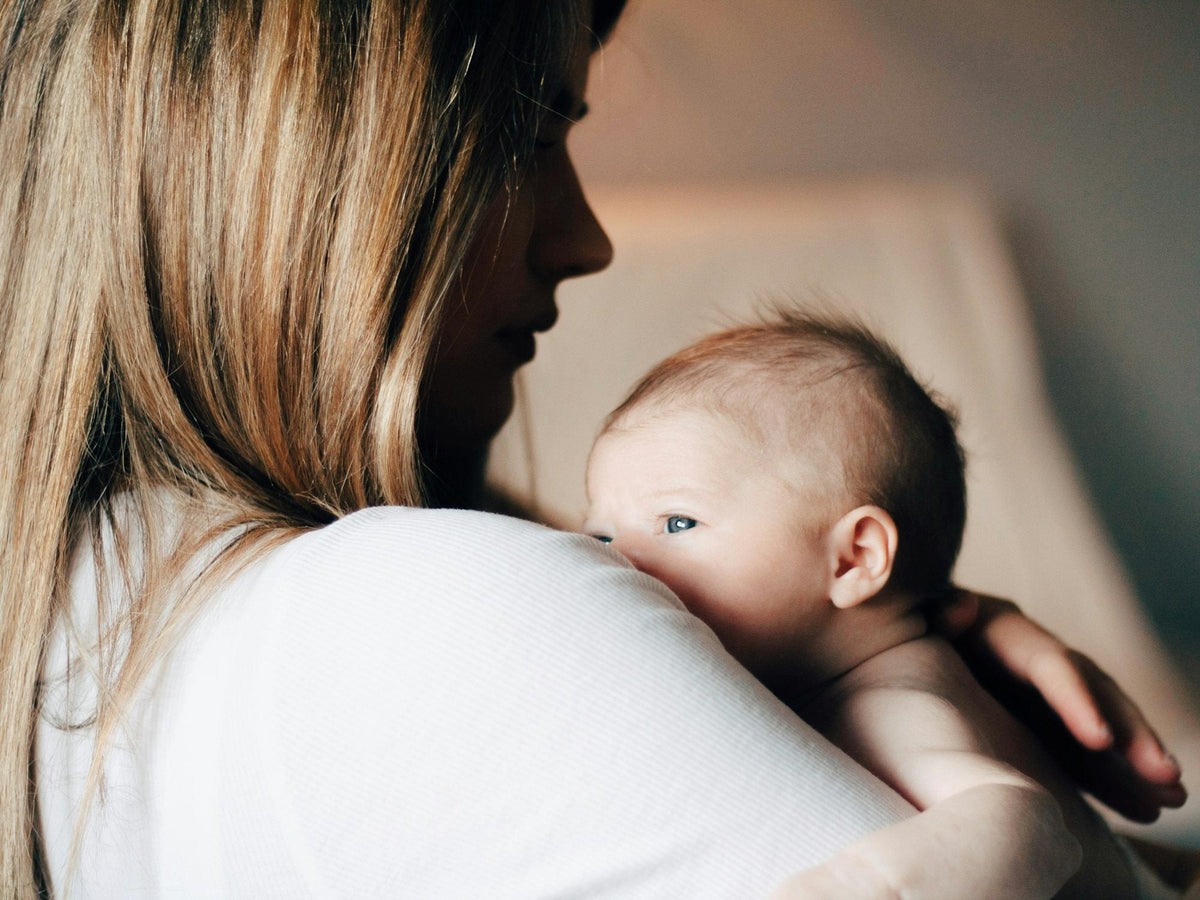 A mother holding her baby close