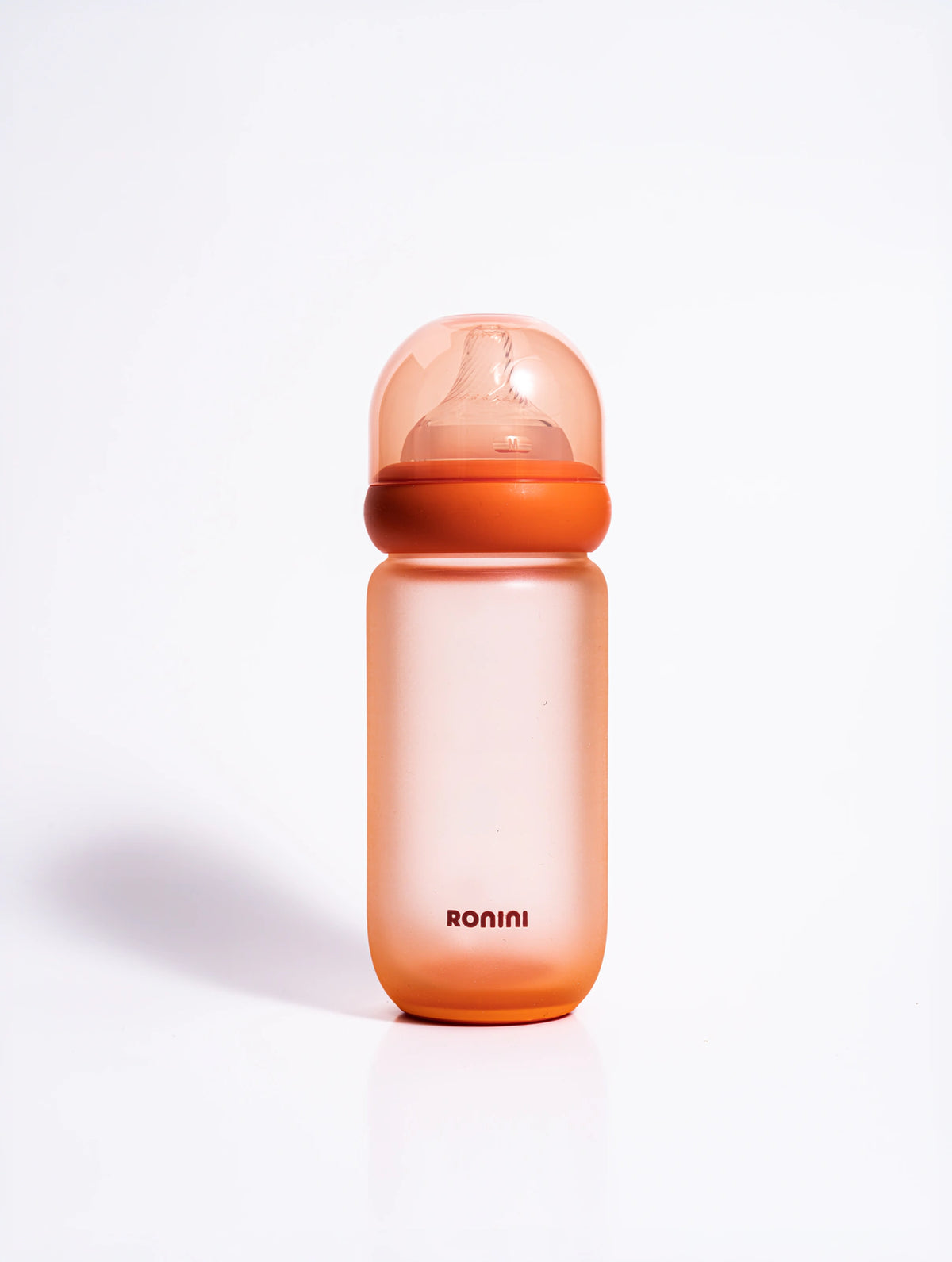 The Wrapped Glass Bottle, an orange glass baby bottle wrapped in silicone, 8 oz